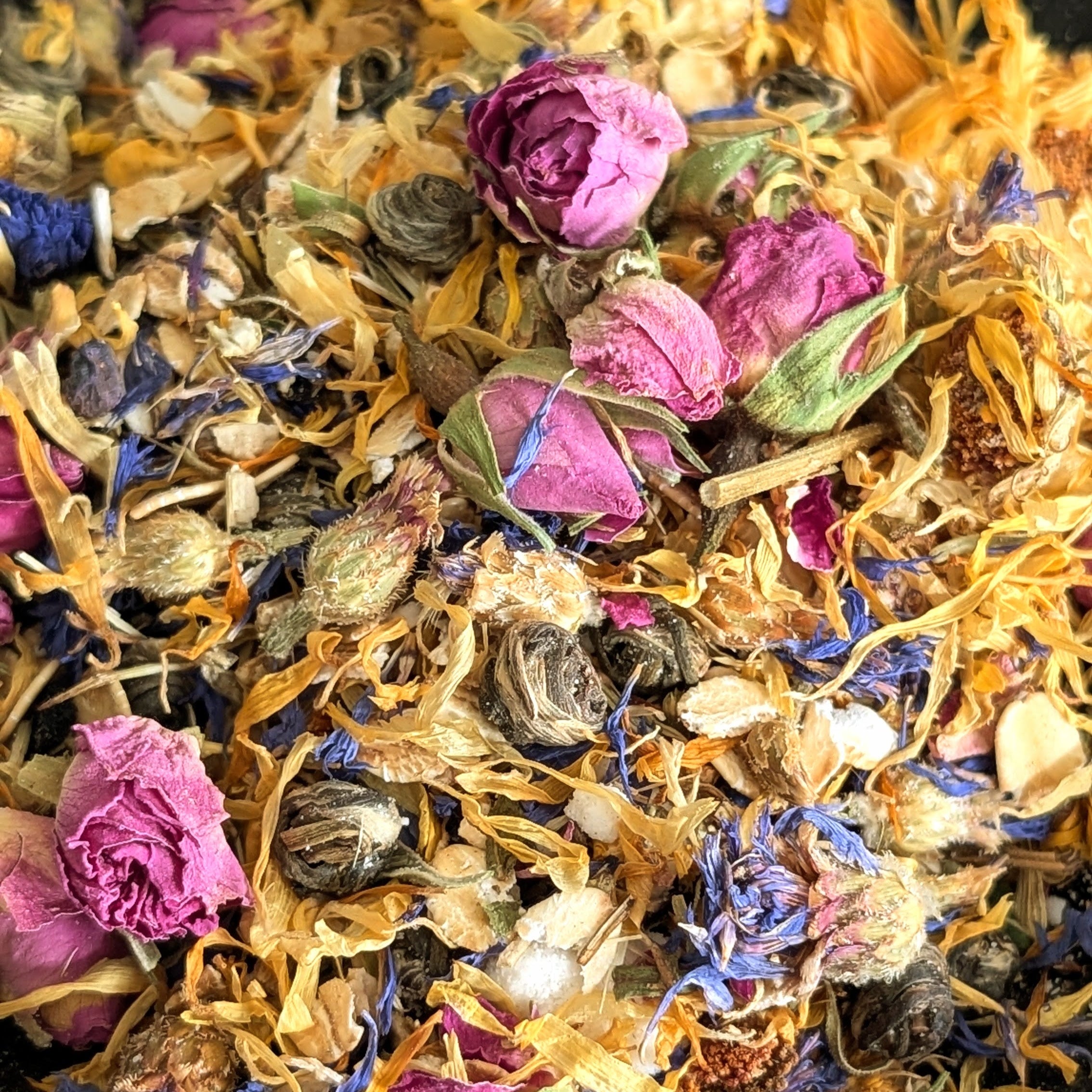 Assorted dried flowers and leaves in a black bowl